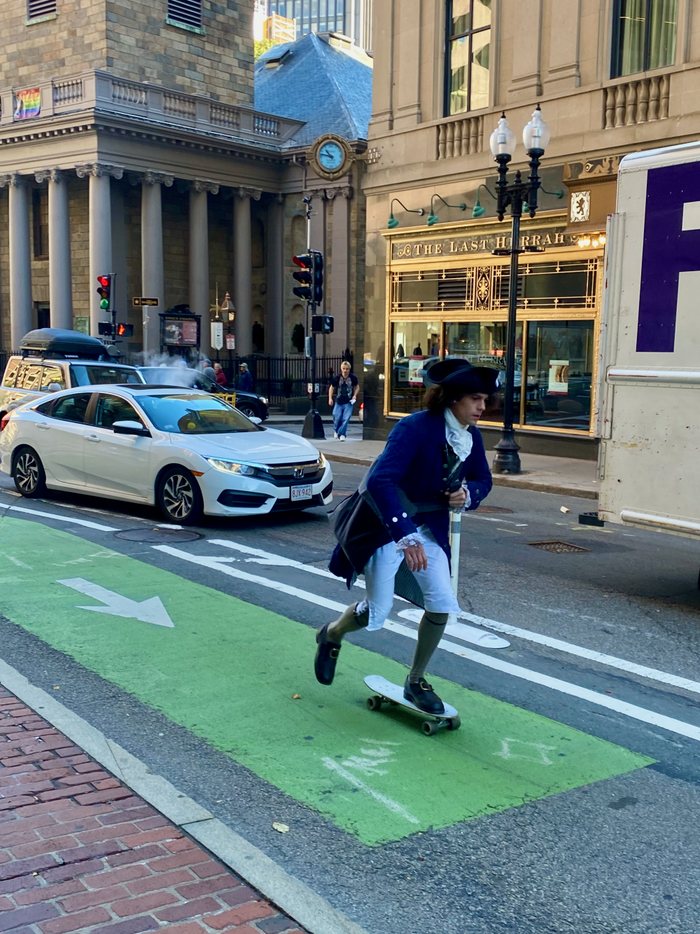 Man skateboarding in Boston in a traditional historic outfit