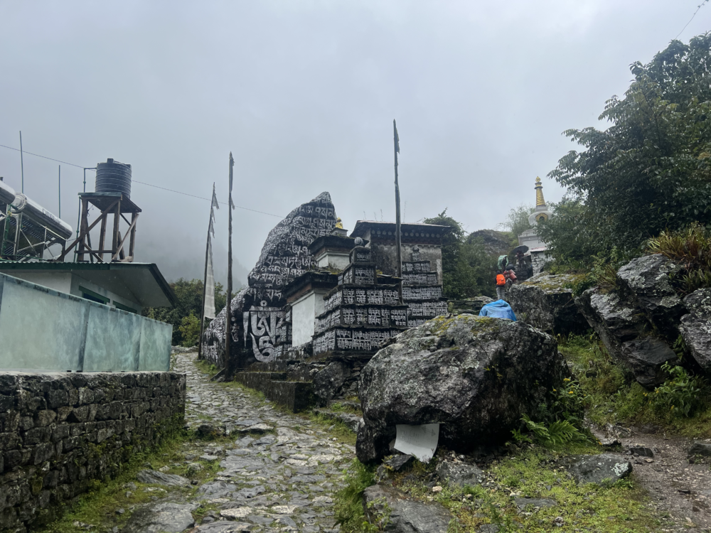 Mani walls in Phakding are sacred Buddhist stone structures lining the trails and village entrances