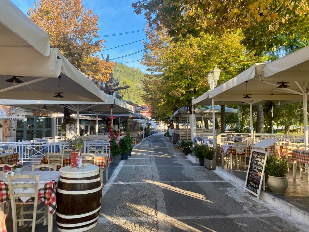 Cafes in the early morning light in Benitses, Corfu