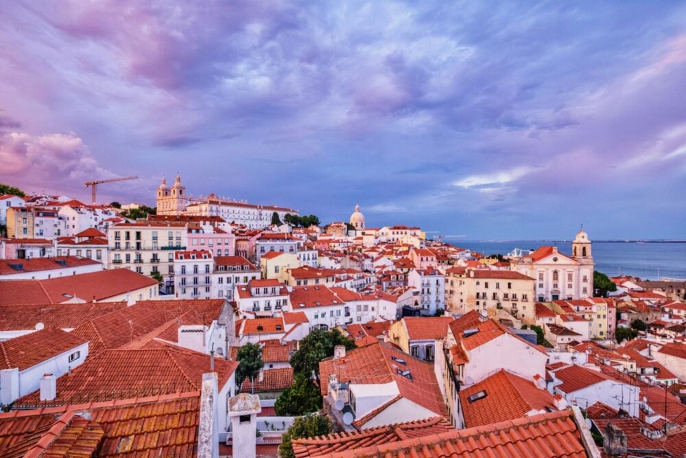 View over Alfama’s terracotta rooftops from a miradouro in Lisbon